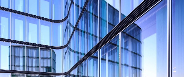 Reflection of the Hamburg harbor i a glass facade of a modern office building.|